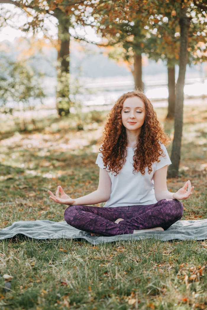 gallery-06 Woman meditating in a serene park during springtime, fostering relaxation and mental wellness.